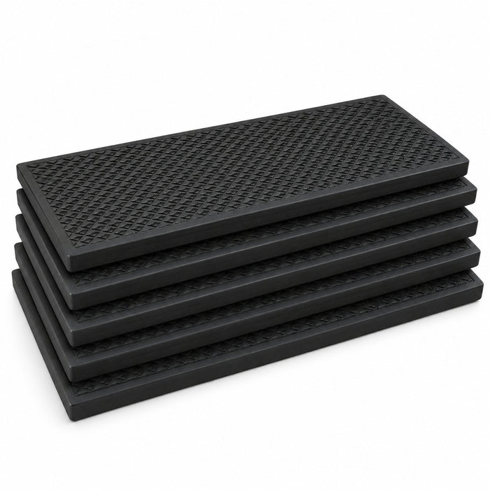 Five black textured rubber stair treads stacked