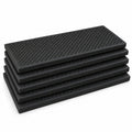 Five black textured rubber stair treads stacked